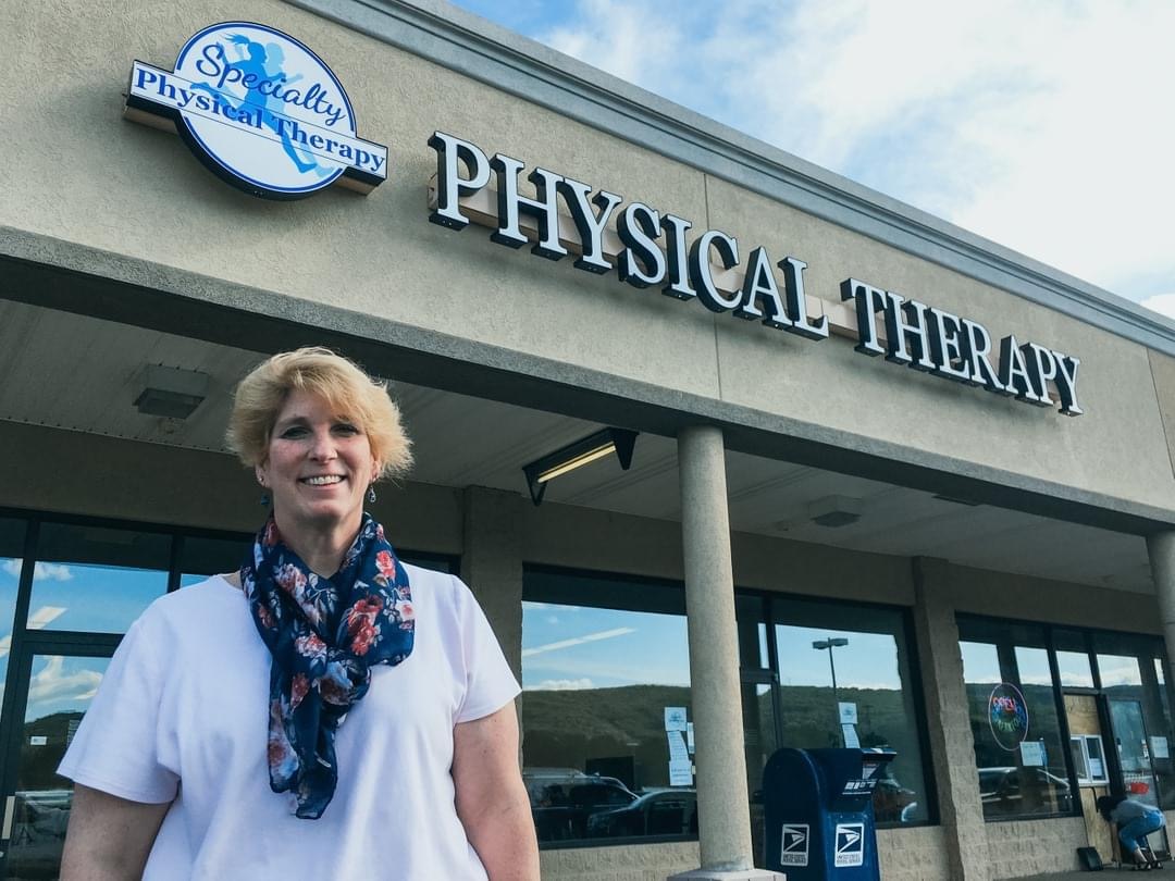 Specialty Physical Therapy building with the owner Kim standing in front of the clinic.